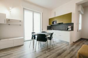 a kitchen and dining room with a table and chairs at AL 13 - Lakeside Leisure & Business in Stresa