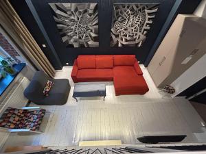 an overhead view of a living room with a red couch at MoHo M in Wrocław