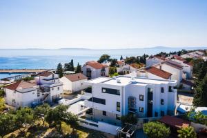 an aerial view of a white house with the ocean at Villa Laverna Annex in Novalja