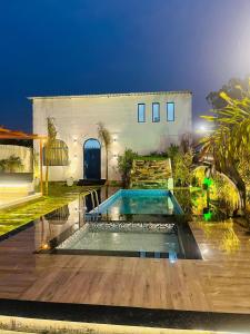 a house with a swimming pool in the yard at Greek House By Housiify in Gurgaon