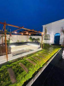 a garden in the middle of a building at night at Greek House By Housiify in Gurgaon