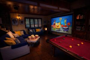 a living room with a pool table and a tv at Panoramic View Village of Villa Luigina Cortona in Castiglion Fiorentino