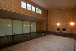 a large bathroom with a tub and a sink at A village in Fujikawaguchiko
