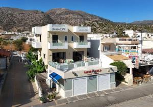 an aerial view of a white apartment building at Smaragdine Beach Hotel in Stalís