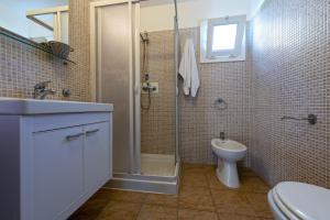 a bathroom with a shower and a toilet and a sink at Village Lake Placid in Silvi Marina +133 photos