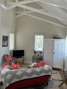 a living room with a couch and a ceiling at Island Studio Apartment in Knysna
