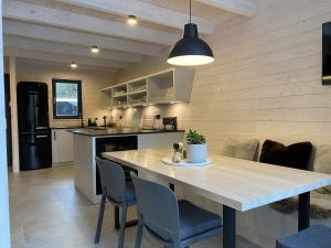 a kitchen and dining room with a table and chairs at Chalet Belveder SPORT in Železná Ruda