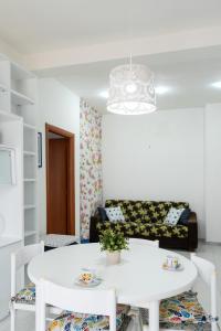a living room with a white table and a couch at San Menaio Apartment by Rentbeat in San Menaio