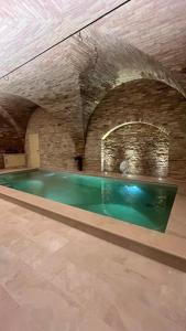 an indoor swimming pool in an old building at Dimora Santa Chiara in Ripatransone