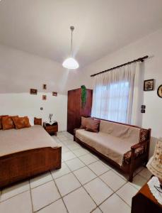 a bedroom with two beds and a window at Sophia in Sfendámion