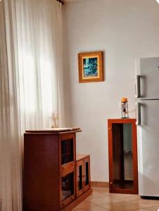 a kitchen with a refrigerator and a table next to a window at Sophia in Sfendámion