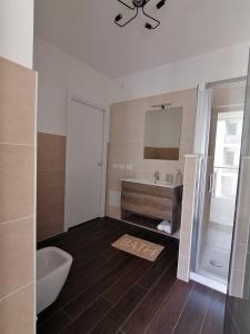 a bathroom with a sink and a tub and a toilet at La Dimora del Cuore - U1598 in Olbia