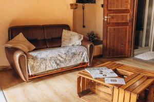 a living room with a leather couch and a coffee table at Agribenessere Agli Abatti in Barge +201 photos