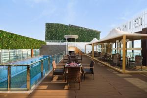 a patio with tables and chairs next to a pool at Ginger Gurugram, Sector 1 in Gurgaon