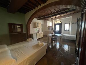 a bedroom with a large bed and a bathroom at LA GRANCIA DEL SANTO in Monticiano +3 photos