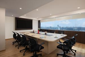 a conference room with a large table and chairs at Ginger Gurugram, Sector 1 in Gurgaon +9 photos