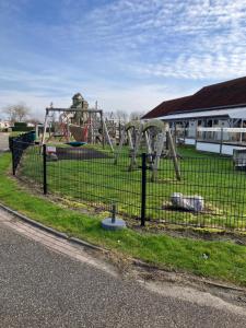 a playground with a slide in a park at Meerchalet in Biggekerke