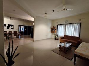 a living room with a couch and a table at Sublime Homestay in Bhubaneshwar