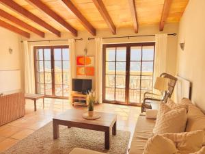 a living room with a couch and a tv at Torre Picada Duplex in Port de Soller
