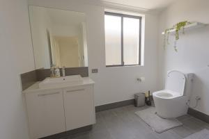 a white bathroom with a toilet and a sink at Shipwreck Park Villas in Westfield +21 photos