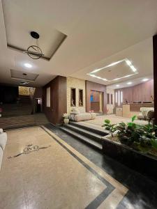 a large lobby with couches and plants in a building at Marquis Pyramids Hotel in Cairo +76 photos