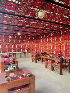 a room filled with lots of tables and red ceilings at Marquis Pyramids Hotel in Cairo