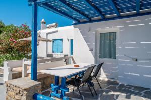 a table and chairs on the patio of a house at Katerina View in Mikonos