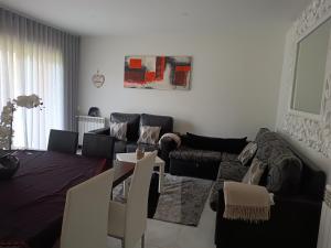 a living room with a couch and a table at Parkofir in Fão