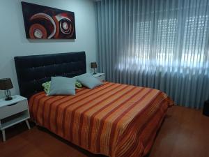 a bedroom with a bed and a window with curtains at Parkofir in Fão +27 photos