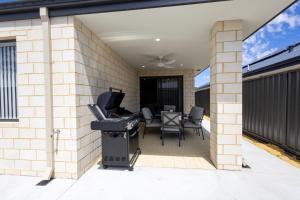 a patio with a grill and a table and chairs at Shipwreck Park Villas in Westfield