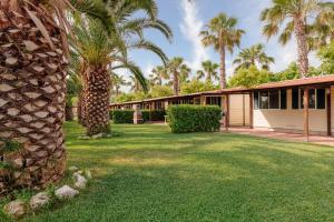 a palm tree in front of a building at Village Lake Placid in Silvi Marina