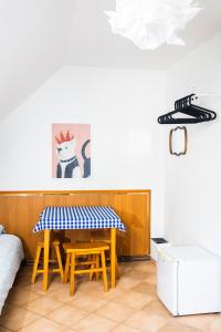 a dining room table with a blue and white checkered table cloth at Hostel Jamnik in Psary +41 photos