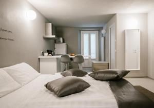 a bedroom with a white bed with pillows on it at Casa Felice by Villa Porta Collection in Luino