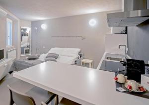 a kitchen with a white table in a room at Casa Felice by Villa Porta Collection in Luino +12 photos