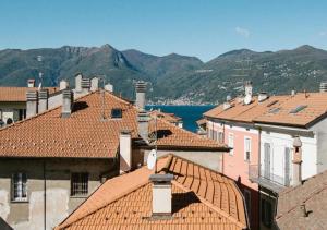 a view of roofs of buildings and the water at Casa Felice by Villa Porta Collection in Luino