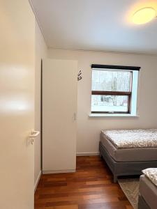 a bedroom with a bed and a window at K&V Apartments Billund Near Legoland #1 in Billund