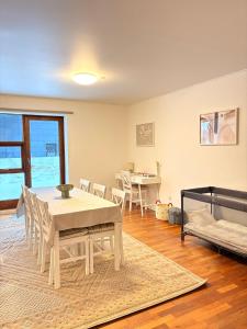 a living room with a table and chairs and a bed at K&V Apartments Billund Near Legoland #1 in Billund