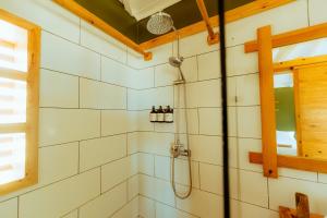 a shower in a white tiled bathroom at Oasis212 Dakhla in Dakhla +96 photos
