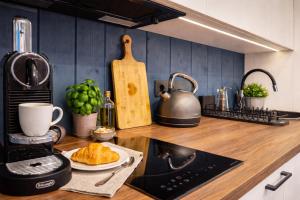 a kitchen counter with a sink and a stove top oven at Berzkrasti Lake House with Private Sauna & Beach in Sigulda +22 photos
