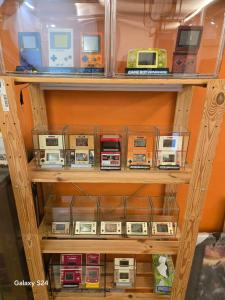 a shelf filled with lots of electronic consoles at Fantasy Homestay in Puli