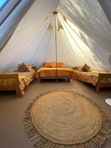 a room with three beds in a tent at Refugio El Tatán in Choros Bajos