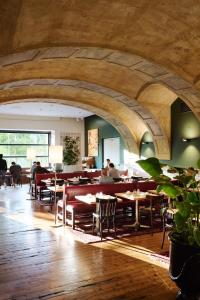 a restaurant with tables and people sitting at tables at Hotel Weitzer Graz - Centre of Graz in Graz