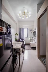 a kitchen and living room with a table and a dining room at R and K staycation in Manila