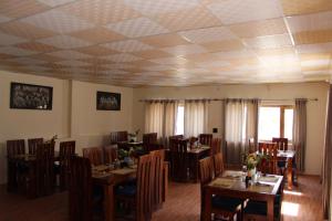 a dining room with wooden tables and chairs at The Walnut Inn Resort in Hundar +23 photos