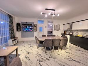 a kitchen and dining room with a table and chairs at Rest House İsmayıllı Villa in İsmayıllı