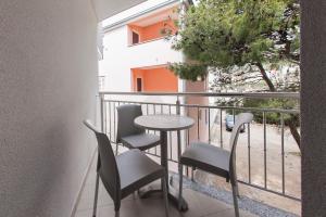 - un balcon avec une table et des chaises dans l'établissement Villa Klara Guest House, à Baška Voda