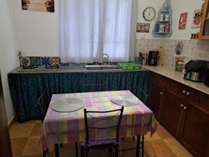 a kitchen with a table with two chairs and a sink at Belle maison in Goodlands