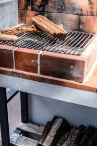 a grill with two sticks on top of it on a table at Porta 29 in Vila Franca do Campo