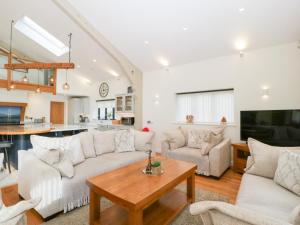 a living room with a couch and a table at Bilsham Meadows in Bristol