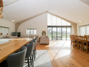 a living room with a long table and chairs at Bilsham Meadows in Bristol